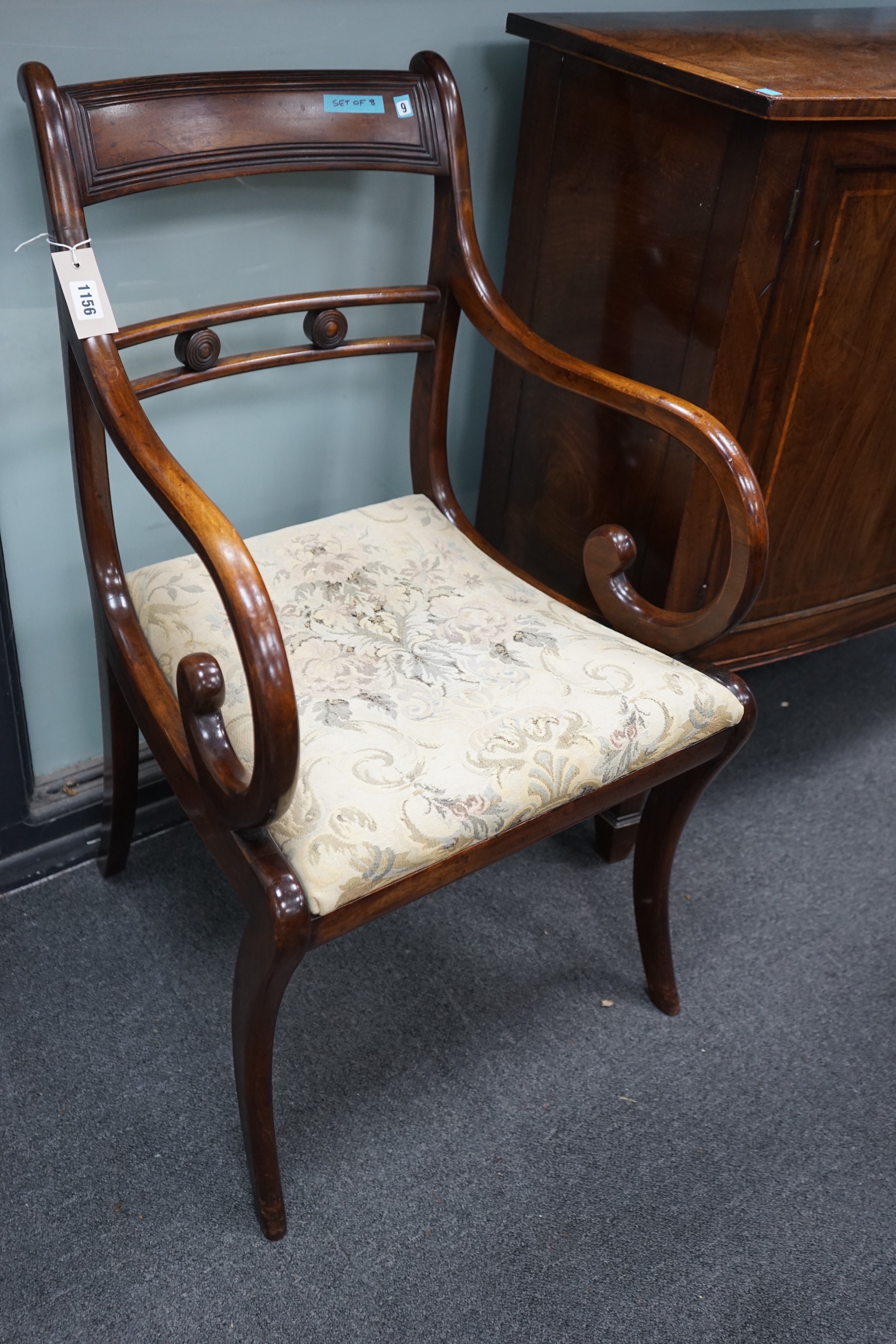 A harlequin set of eight Regency and later mahogany dining chairs on sabre legs, two with arms